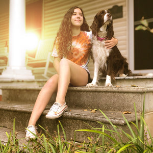 Girl wearing Amber Swirl Tee sitting on porch with pup